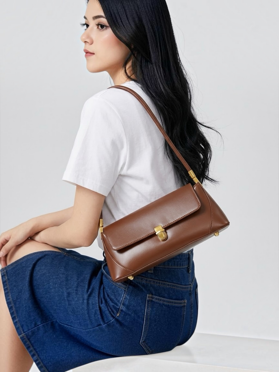 Brown leather structured mini shoulder bag with gold detail